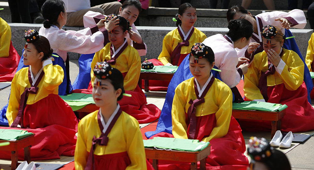 Women wearing South Korea traditional dresses, attend at the 44th Coming of Age Day ceremony in Seoul, South Korea, Monday, May 16, 2016